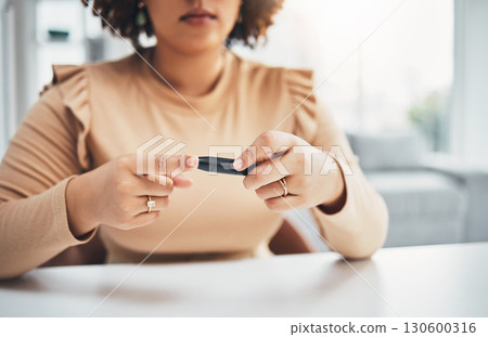 Diabetes, finger of black woman and blood test in hands, healthcare and medicine in home. Health, innovation and technology, diabetic person with digital glucometer checking glucose or sugar level. Diabetes, finger of black woman and blood test in hands, healthcare and medicine in home. Health, innovation and technology, diabetic person with digital glucometer checking glucose or sugar level. 130600316