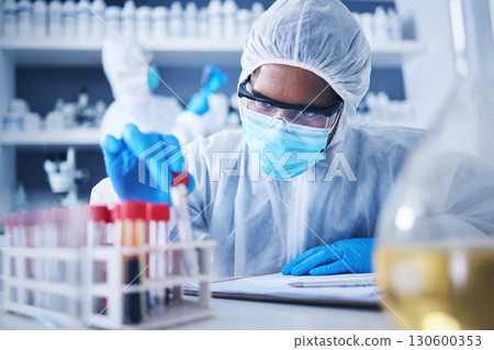 Serious, covid test tube or black man in lab with blood for research, medical exam and sample analysis. Healthcare, biotechnology or male scientist thinking with liquid vial, medicine and vaccine 130600353