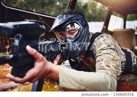 Paintball, gun or soldier in a shooting game with fast action on a fun battlefield on holiday. Military mission, target or focused man with war weapons gear for survival in an outdoor competition 130600358