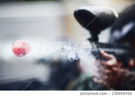 Closeup, person and paintball gun shooting with ball for fun, extreme and sport, fitness and training. Zoom, marker, and target, practice and game with people competing, speed and power 130600456