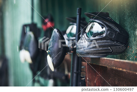 Paintball, equipment and helmets or mask for protection for sports, competition or fun game. Sport, paint ball and safety gear for a recreation battle or competitive match by an outdoor battlefield. 130600497