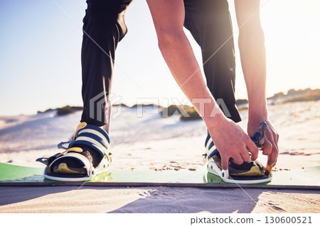 Sand, board and man tie shoes ready for desert surfing, extreme sports and action hobby in nature. Freedom, adventure and feet of athlete outdoors for fitness, exercise and dune surfer training Sand, board and man tie shoes ready for desert surfing, extreme sports and action hobby in nature. Freedom, adventure and feet of athlete outdoors for fitness, exercise and dune surfer training 130600521