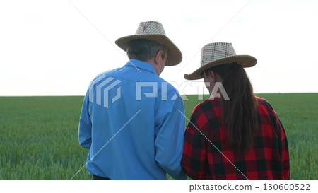 Agriculture and technology fusion, Two generations in farming, Modern farming attire, Professional farm management, Innovative countryside, Tablet-driven farm solutions, Sustainable rural development 130600522