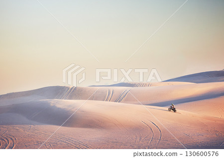 Sand landscape, motorbike or man on moto cross in desert space for sport workout, sunset ride or exercise on hill. Nature, sky or man riding for speed adventure in Dubai for training, fitness or race 130600576