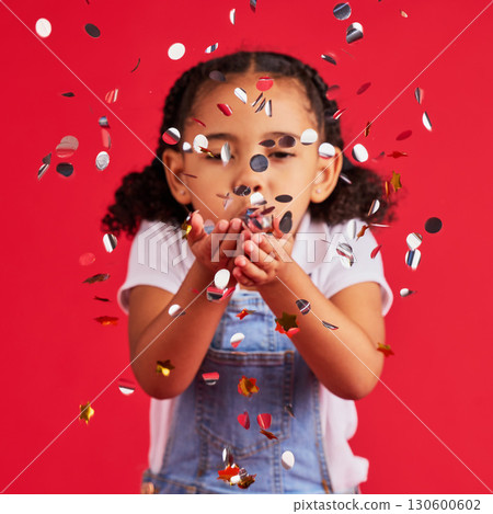 Young girl, child blowing confetti with party and celebration, silver and glitter isolated against red background. Fun, youth and kid at event, celebrate and birthday in studio with decoration Young girl, child blowing confetti with party and celebration, silver and glitter isolated against red background. Fun, youth and kid at event, celebrate and birthday in studio with decoration 130600602
