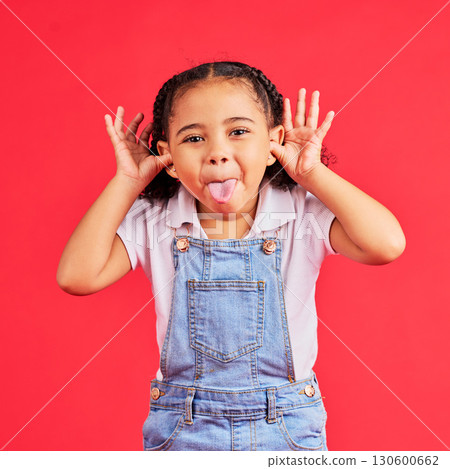 Child, portrait and tongue out on isolated red background in goofy, silly games and playful facial expression. Happy, kid and little girl with funny face in comic emoji, charades and studio activity 130600662