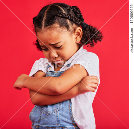 Kid, arms crossed or crying expression on isolated red background in depression, mental health or burnout. Upset, unhappy or little girl with sad, sulking or grumpy face in bullying crisis or anxiety 130600663