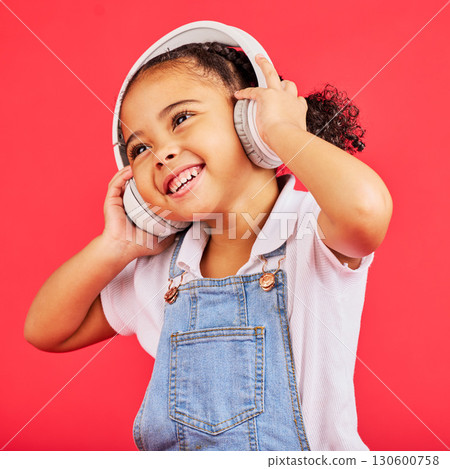 Dancing, kid and headphones for music, fun radio and girls podcast on isolated red background and studio. Smile, happy and energy child listening to dance audio, sound and streaming media on backdrop Dancing, kid and headphones for music, fun radio and girls podcast on isolated red background and studio. Smile, happy and energy child listening to dance audio, sound and streaming media on backdrop 130600758
