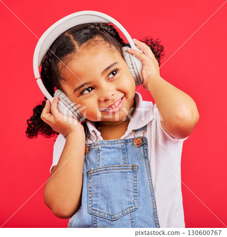 Happy, kid and headphones for music, radio and fun podcast on isolated red background and dancing studio. Smile, little girl and child listening to dance audio, sound and streaming media on backdrop Happy, kid and headphones for music, radio and fun podcast on isolated red background and dancing studio. Smile, little girl and child listening to dance audio, sound and streaming media on backdrop 130600767