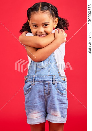 Portrait, hug and girl in studio, happy and smile against red background with mockup. Face, love and caring toddler standing against space, embrace and positive, smiling and self love while isolated 130600858