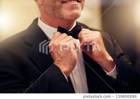 Hands, wedding and bow tie with a groom getting ready for his marriage ceremony of tradition or celebration. Fashion, event and celebrating with a man wearing a suit as a gentleman to be married Hands, wedding and bow tie with a groom getting ready for his marriage ceremony of tradition or celebration. Fashion, event and celebrating with a man wearing a suit as a gentleman to be married 130600898