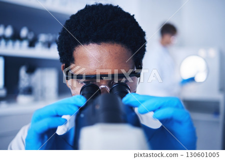 Microscope, science and black man face working in laboratory, medical research or virus analysis. Scientist, microbiology or medical worker check investigation, study innovation or dna pathology test 130601005