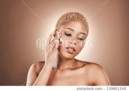 Moisturizer, spa cream and black woman with beauty skincare and face lotion in studio. Brown background, isolated and collagen cosmetic dermatology of a model with makeup and skin glow for facial 130601149