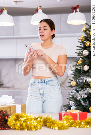 in New Year s atmosphere, girl calmly talks on phone 130601265