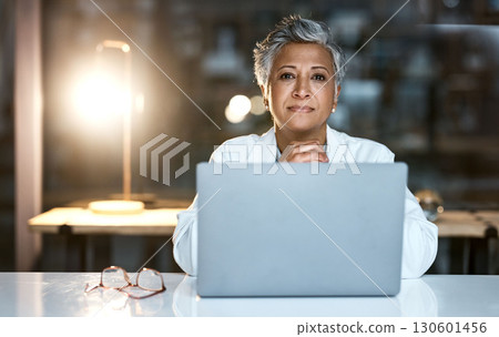 Doctor, laptop and portrait of senior woman in hospital working late or overtime on email, telehealth or research. Elderly, healthcare and confident female medical physician by computer at night. 130601456