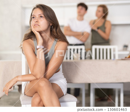 Mother-in-law and son scold young daughter-in-law in home kitchen 130601463