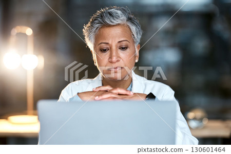 Senior woman, doctor and laptop at night thinking for healthcare solution, idea or strategy at hospital. Elderly female medical expert working late on computer and contemplating decision or choice 130601464