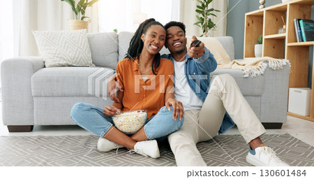 Happy, black couple and watching tv with popcorn for movie, show or video in home, living room or house. Dating, man and woman relax with media on television, channel or streaming a series online Happy, black couple and watching tv with popcorn for movie, show or video in home, living room or house. Dating, man and woman relax with media on television, channel or streaming a series online 130601484