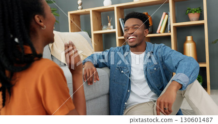 Couple, sitting and talking in lounge, funny conversation and laugh on home date, happiness and playful entertainment. Dating, quality bonding time, and smile together on floor, romantic and sweet 130601487