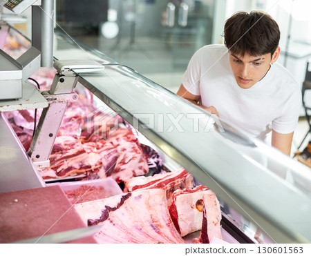 shopper makes his choice from assortment. 130601563