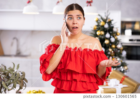 young woman was upset by an unpleasant phone call young woman was upset by an unpleasant phone call 130601565