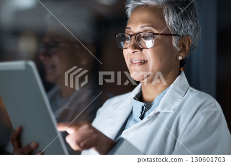 Medical, research and night with doctor and tablet for planning, medicine and schedule. Technology, review and digital with senior woman reading report for healthcare, science and life insurance news 130601703