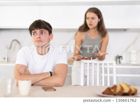 Young woman quarrels with young guy in kitchen 130601762