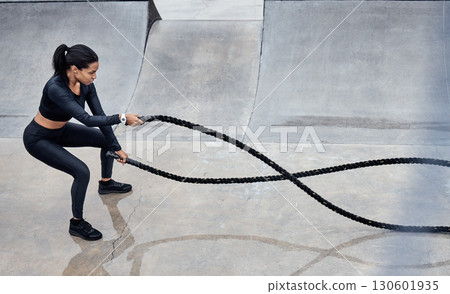 Fitness, battle ropes and strong with a black woman athlete outdoor for a workout from above. Exercise, energy and power with a female training outside using a heavy rope for cardio or endurance 130601935
