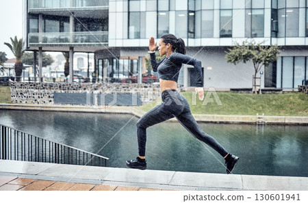 Run, rain and black woman with fitness, workout and training for marathon, wellness and healthy lifestyle. Wet, African American female athlete and runner outdoor, practice and balance for energy 130601941