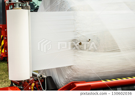 Bale of hay wrapped in plastic foil 130602036