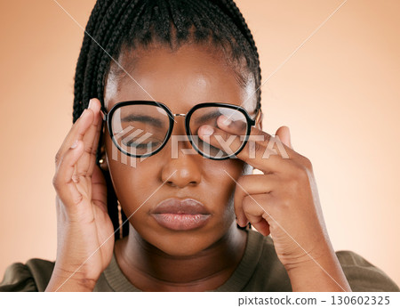 Black woman with glasses, tired and rubbing eyes, burnout and stress isolated on studio background. Vision, eye sight and overworked or exhausted person with spectacles, hands on face from allergy. Black woman with glasses, tired and rubbing eyes, burnout and stress isolated on studio background. Vision, eye sight and overworked or exhausted person with spectacles, hands on face from allergy. 130602325