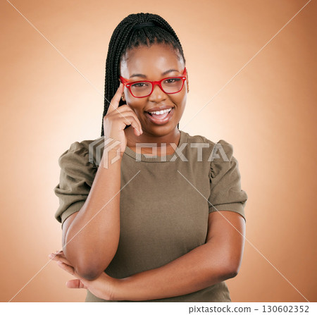 Portrait, glasses or black woman with smile, leadership or confident girl on brown studio background. Face, African American female or happy lady with eyewear, comfortable or smart person on backdrop 130602352