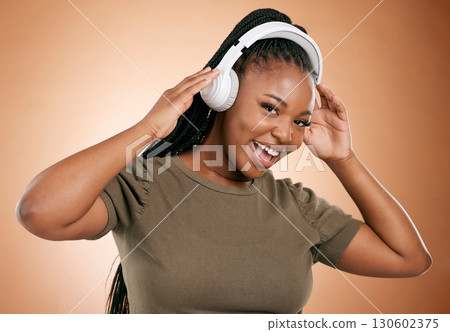 Headphones, music and black woman in portrait isolated on studio background for mental health, energy and podcast. Happy african person listening to audio technology with smile on face for sound Headphones, music and black woman in portrait isolated on studio background for mental health, energy and podcast. Happy african person listening to audio technology with smile on face for sound 130602375