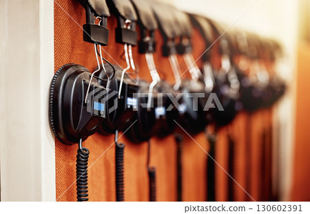 Music, equipment and headphones on display at a studio for production, streaming and radio broadcast. Sound, headset and devices displayed for listening to a track, audio or record for entertainment 130602391