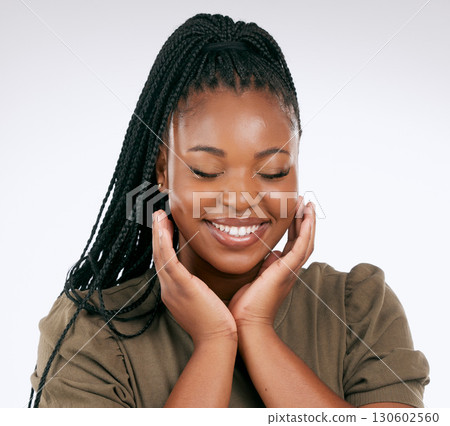 Happy, calm and black woman smile with skincare, beauty and facial wellness in studio. White background, isolated and skin glow of relax african model with dermatology, cosmetics and face self care 130602560