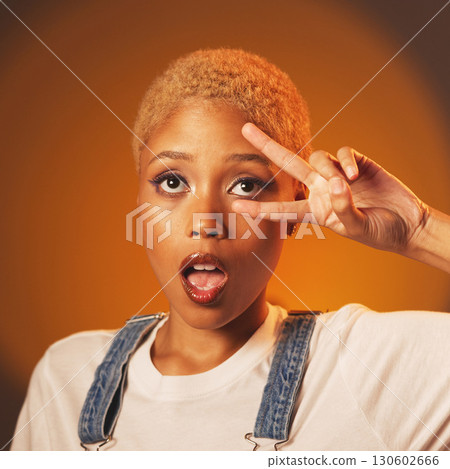Peace sign, surprise and black woman with success, casual outfit and brown studio background. African American female, lady and expression with hand gesture, wow and fashion with emoji and motivation 130602666
