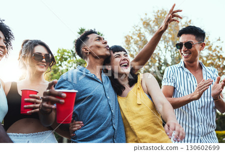 Drinks, party and a couple of friends dancing outdoor to celebrate at festival, concert or social event. Diversity young men and women people together in summer, happy and drinking alcohol in crowd 130602699