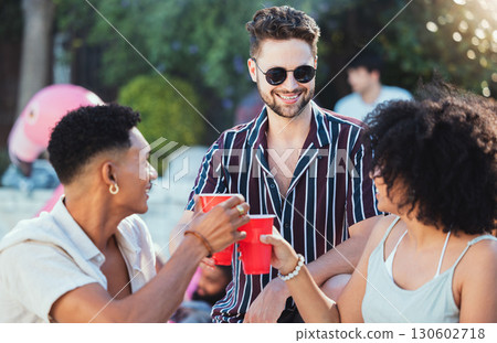 Party, diversity and cheers with friends outdoor together in summer for a social gathering or celebration event. Alcohol, toast or birthday with a young man and woman friend group celebrating outside 130602718