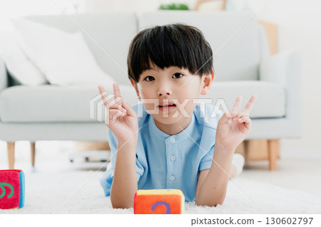 Boy playing with number dice 130602797