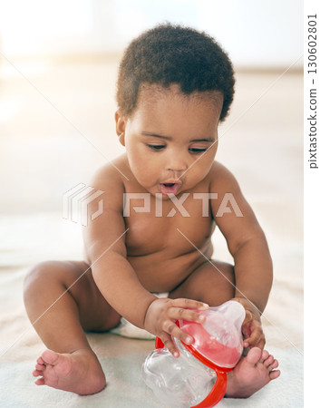 Kids, black baby and girl with a bottle sitting on a blanket on the floor of a home for child development. Children, cute and curious with a newborn infant learning or growing alone in a house Kids, black baby and girl with a bottle sitting on a blanket on the floor of a home for child development. Children, cute and curious with a newborn infant learning or growing alone in a house 130602801