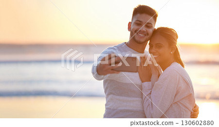 Couple, beach selfie and sunset love for happiness, save the date engagement announcement or mockup. Man, woman and take photograph at sea of happy holiday, peace or relax at ocean, travel or freedom 130602880