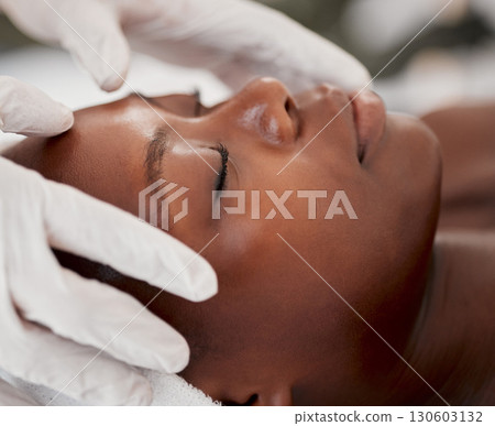 Massage, facial and relax with black woman in spa for holistic treatment, beauty and skincare. Peace, luxury and zen with girl customer in salon for cosmetology, wellness and physical therapy 130603132