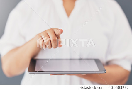 Communication, app and hands of a woman with a tablet isolated on a studio background. Social media, contact and employee pointing a finger for connection to technology, internet and business 130603282