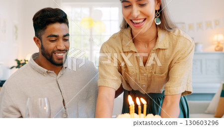 Cake, birthday candles and interracial couple celebration and party together with love at home. Candles, smile and happy people with dinner date and food in a house with support, giving and care 130603296
