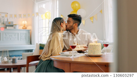 Cake, love and kiss or birthday with interracial couple celebration and present with party at home. Candles, wine and happy people with dinner date and food in a house with support and alcohol 130603297