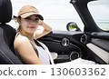 Cute woman in the passenger seat 130603362