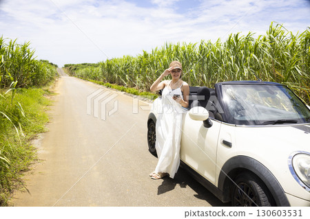 A young woman sightseeing in Okinawa by car A young woman sightseeing in Okinawa by car 130603531