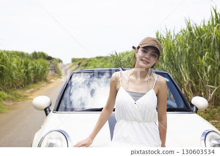 A young woman sightseeing in Okinawa by car 130603534
