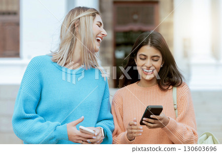 Friends, women laugh at meme on smartphone, social media and students on campus, outdoor and comedy online. Connection, funny post and 5g network, communication and technology with Gen z youth 130603696