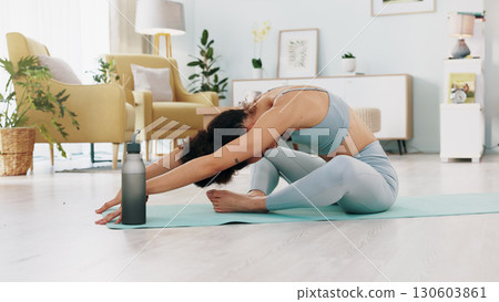 Fitness, yoga or meditation stretching woman for workout in the living room of her house. Girl with chakra focus, mindset or balance while training, exercise or health with zen pilates for wellness. Fitness, yoga or meditation stretching woman for workout in the living room of her house. Girl with chakra focus, mindset or balance while training, exercise or health with zen pilates for wellness. 130603861